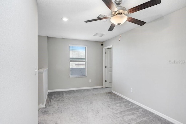 carpeted spare room featuring ceiling fan