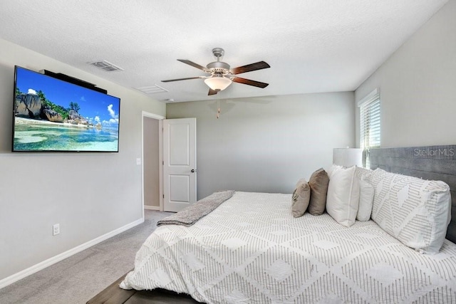 carpeted bedroom with a textured ceiling and ceiling fan