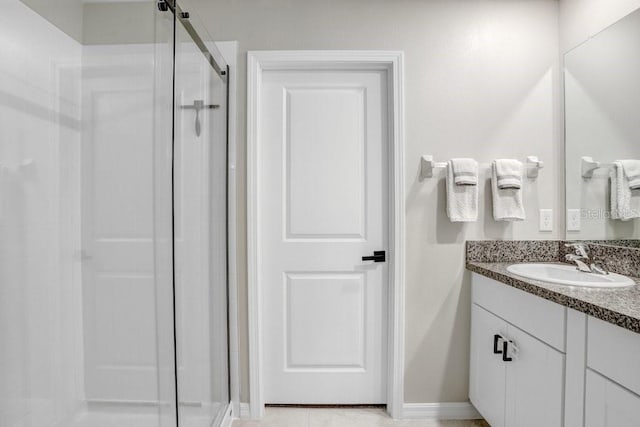 bathroom with vanity and a shower with shower door