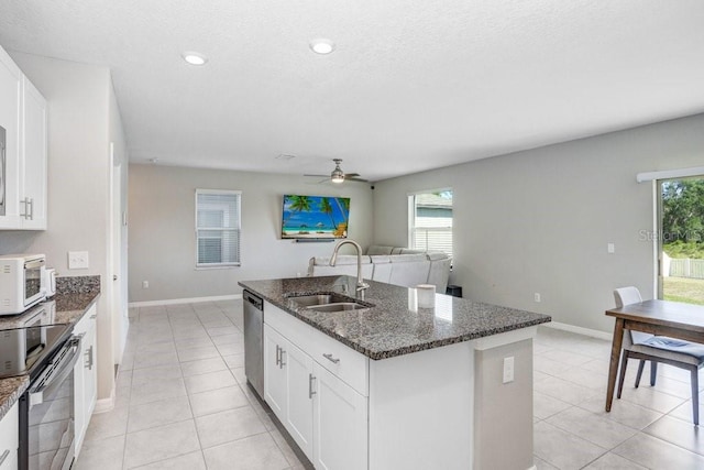 kitchen featuring white cabinets, sink, a center island with sink, and stainless steel appliances