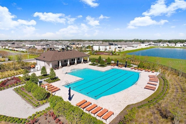 view of swimming pool with a patio and a water view