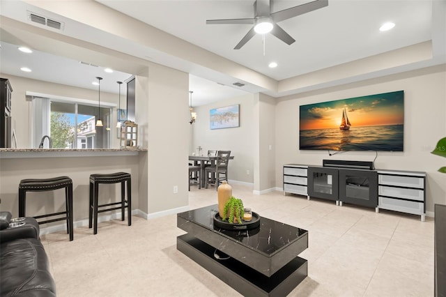 tiled living room featuring ceiling fan