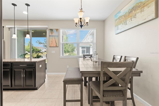 dining space with light tile patterned floors and a chandelier