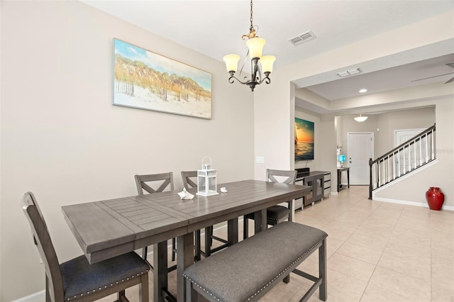 tiled dining space featuring a chandelier