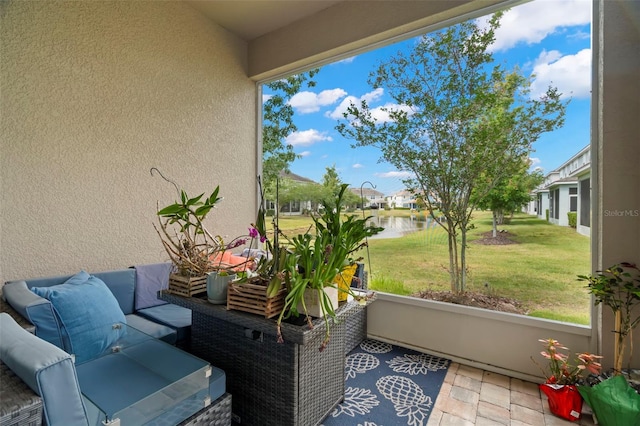 sunroom / solarium with a water view