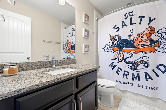 bathroom featuring vanity, tile patterned floors, and toilet