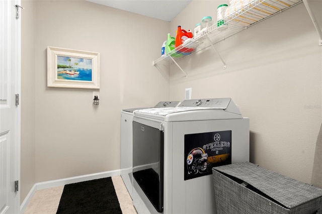 laundry area with tile patterned floors and washer and clothes dryer