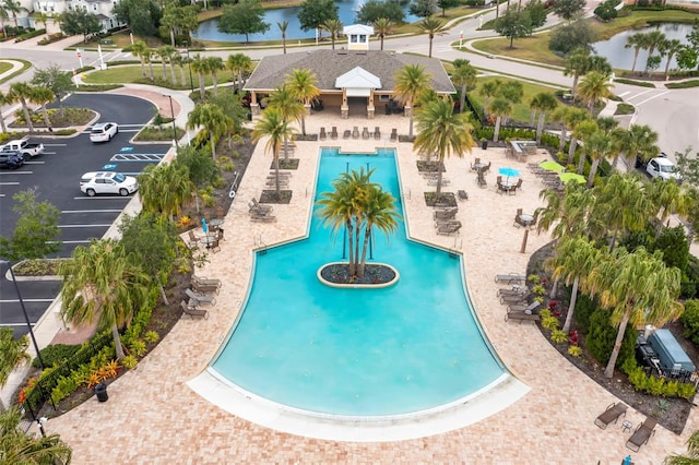 view of swimming pool featuring a patio and a water view