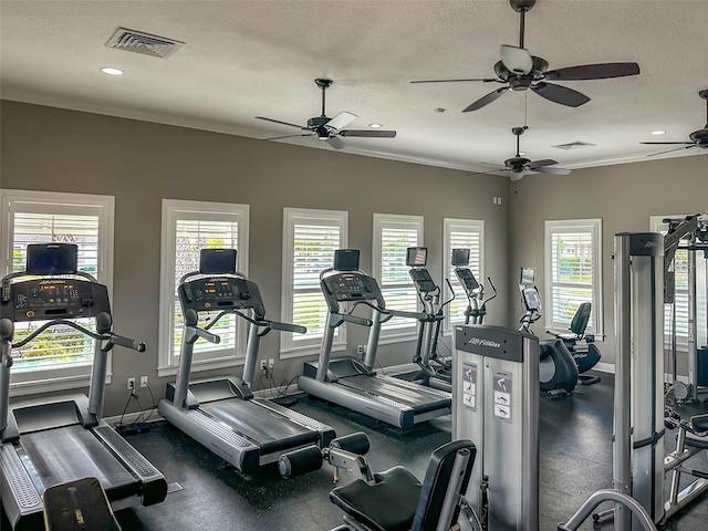 exercise room featuring crown molding and a textured ceiling