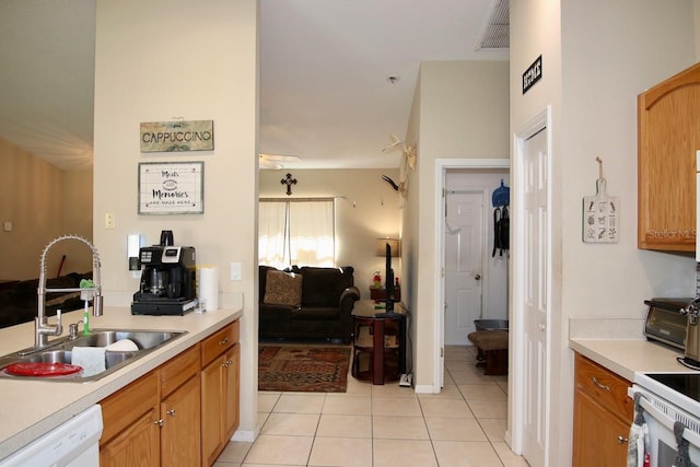 kitchen featuring dishwasher, sink, and light tile patterned floors