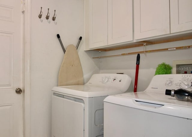 washroom with cabinets and washer and clothes dryer