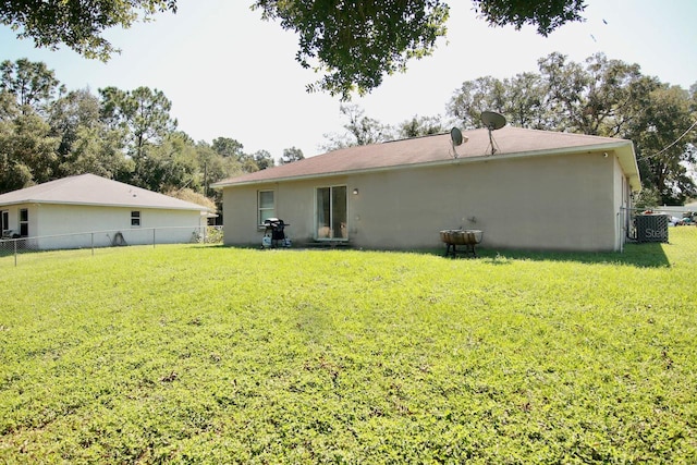 rear view of property featuring a yard