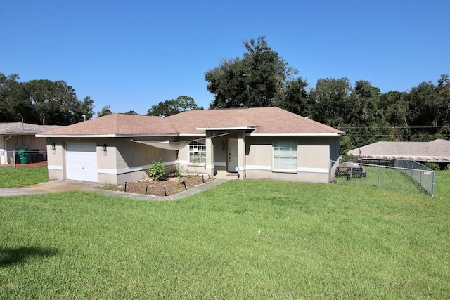 single story home with a garage and a front lawn