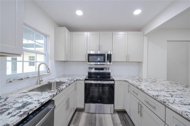 kitchen featuring sink, stainless steel appliances, and white cabinets