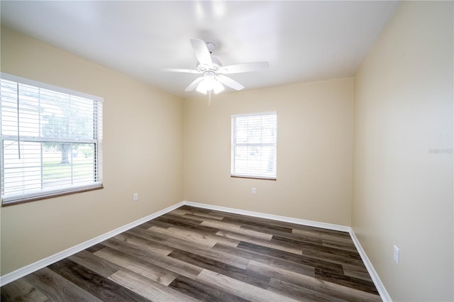 empty room featuring dark wood-type flooring and ceiling fan