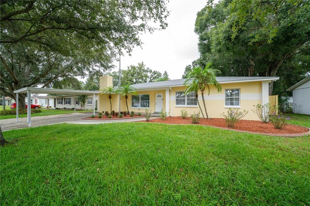 ranch-style home with a front lawn and a carport