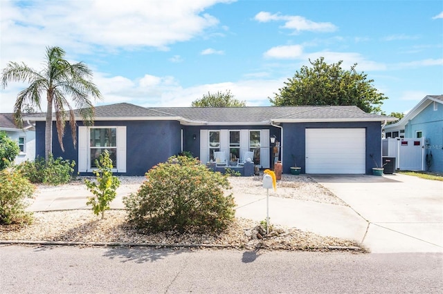 ranch-style house with a garage and cooling unit