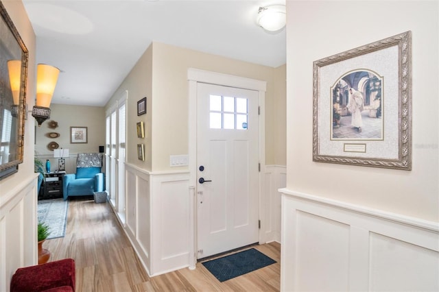 entrance foyer with light hardwood / wood-style floors and a wealth of natural light