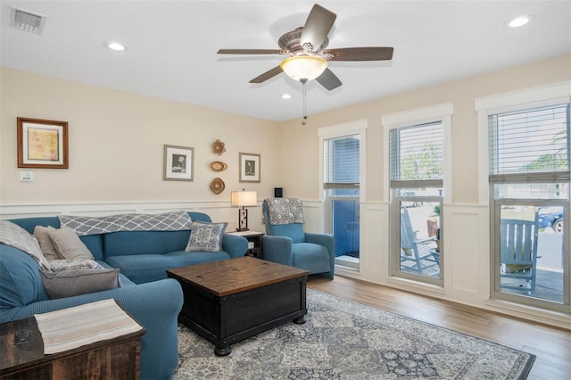 living room with hardwood / wood-style floors and ceiling fan