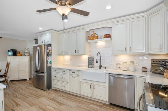 kitchen featuring decorative backsplash, light hardwood / wood-style floors, sink, and appliances with stainless steel finishes