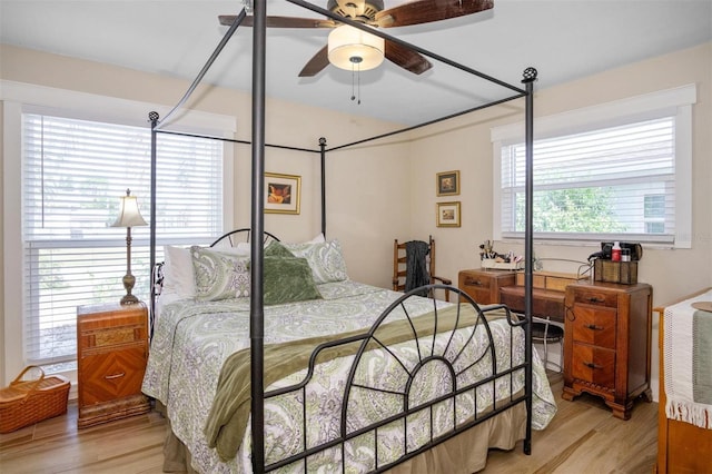 bedroom with light wood-type flooring and multiple windows