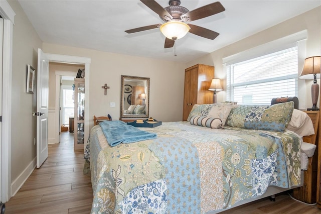 bedroom featuring wood-type flooring and ceiling fan