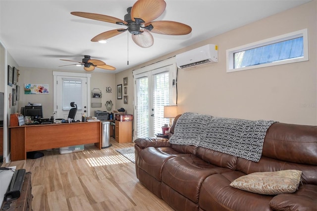 living room with ceiling fan, french doors, a wall mounted air conditioner, and light wood-type flooring