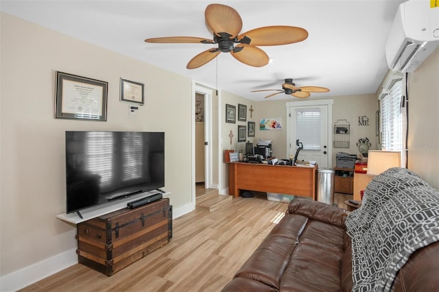 living room with ceiling fan, a wall mounted air conditioner, and light wood-type flooring