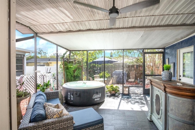 sunroom featuring ceiling fan