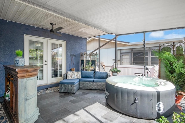 view of patio with outdoor lounge area, ceiling fan, and a hot tub