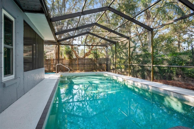 view of pool with a fenced in pool, a lanai, and fence