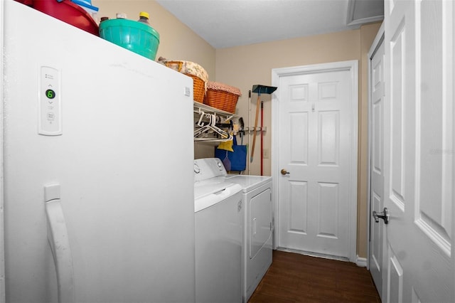 laundry area with dark wood-style floors, laundry area, and washer and clothes dryer