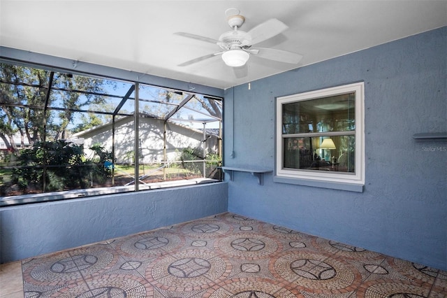 unfurnished sunroom with a ceiling fan