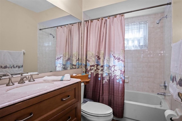 bathroom featuring toilet, shower / tub combo with curtain, and vanity