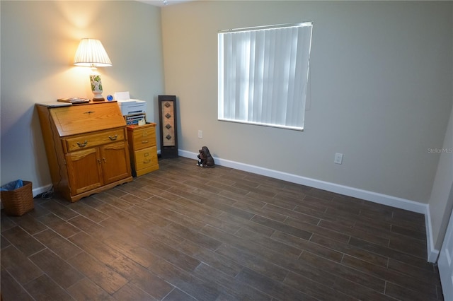 interior space with baseboards and dark wood-type flooring