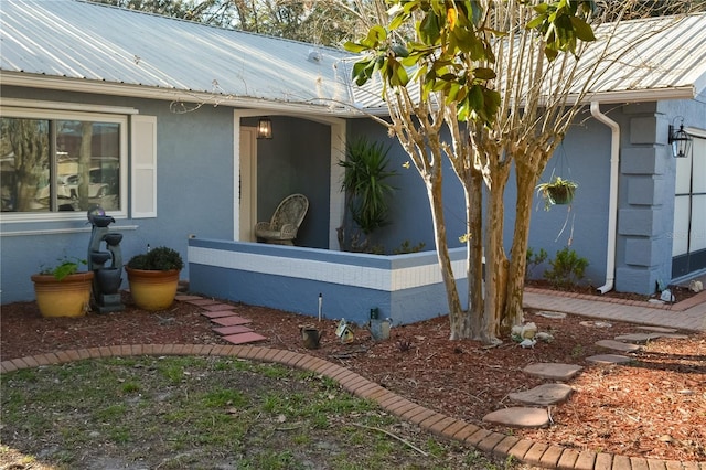 view of home's exterior featuring metal roof and stucco siding