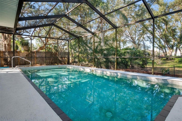 view of pool featuring glass enclosure, fence, and a fenced in pool