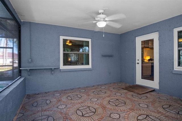 interior space featuring ceiling fan