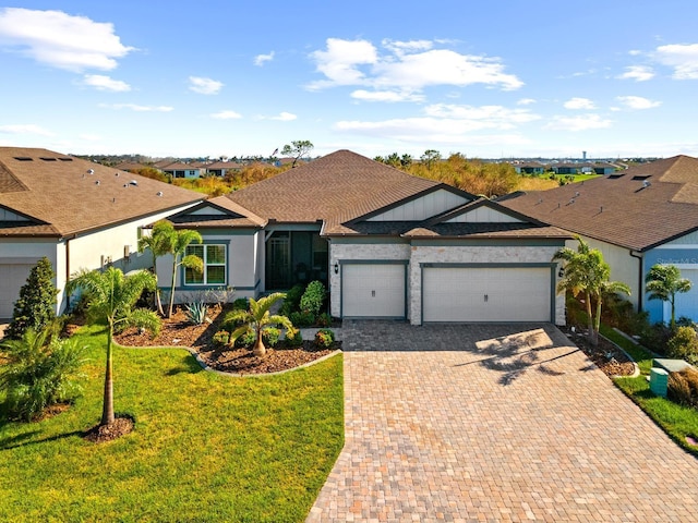 ranch-style house with a garage and a front lawn