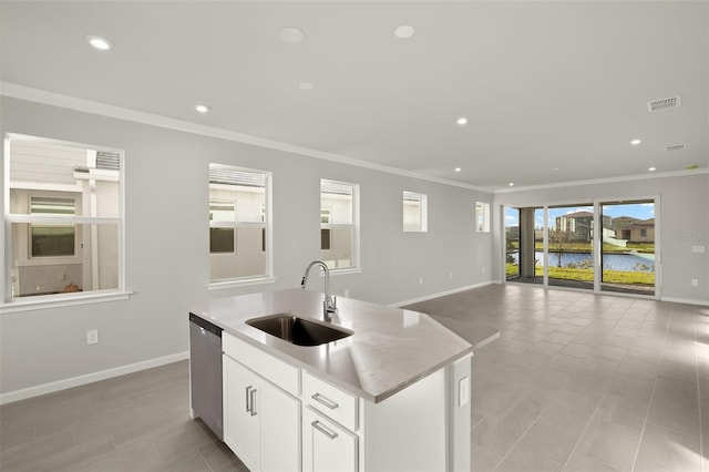 kitchen featuring dishwasher, white cabinets, sink, an island with sink, and plenty of natural light