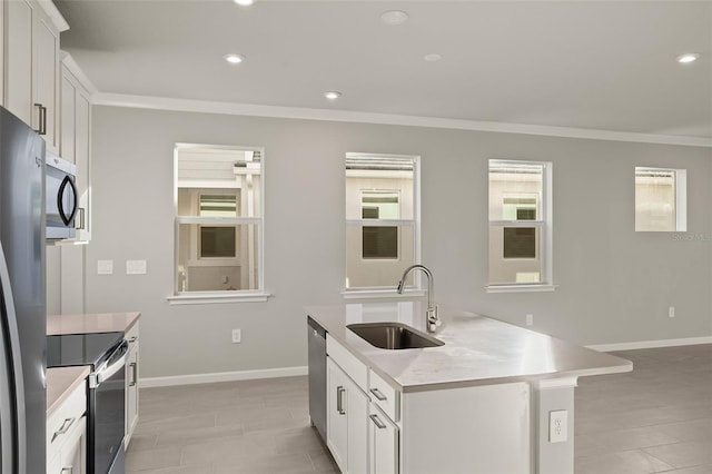 kitchen featuring white cabinets, a center island with sink, sink, and stainless steel appliances