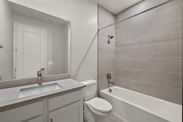 full bathroom with vanity, tiled shower / bath combo, and toilet