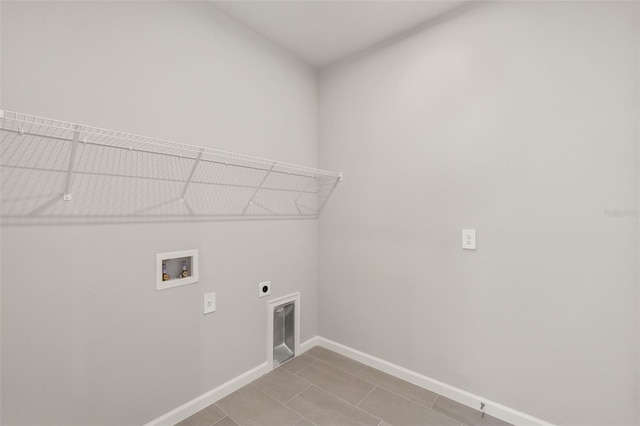 laundry area featuring hookup for a washing machine, light tile patterned floors, and electric dryer hookup