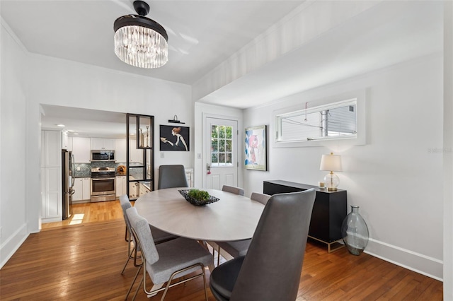 dining room featuring hardwood / wood-style flooring and a notable chandelier