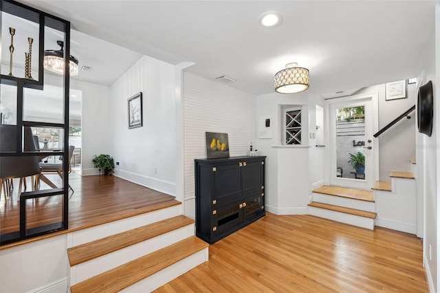 stairway with hardwood / wood-style flooring