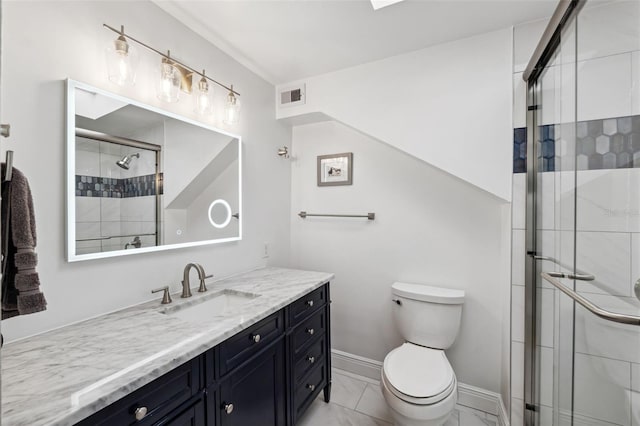 bathroom featuring vanity, toilet, and an enclosed shower