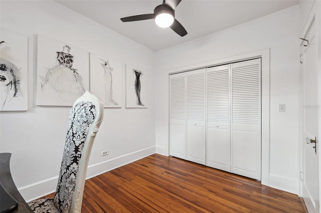 interior space featuring dark wood-type flooring, ceiling fan, and a closet