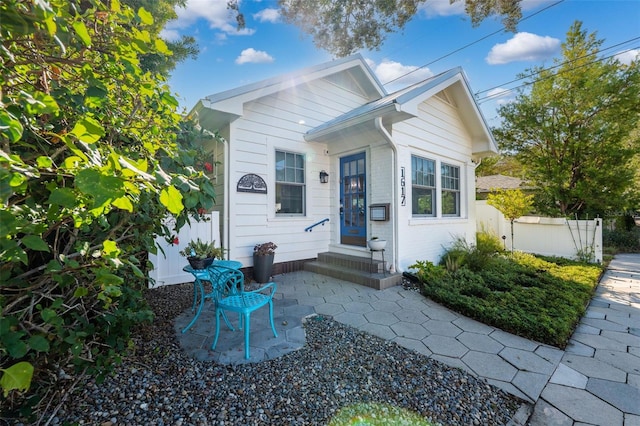 bungalow-style house with a patio