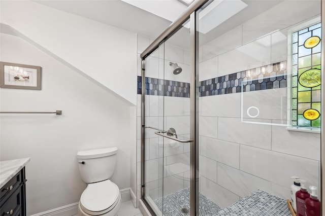 bathroom featuring vanity, toilet, and walk in shower