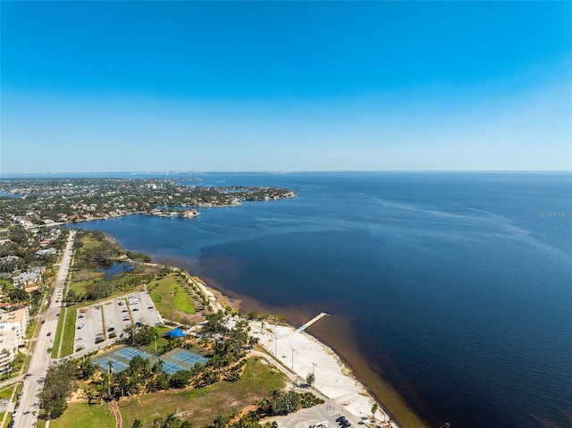 birds eye view of property with a water view and a beach view